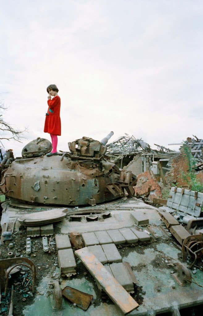 Chechnya, 1996. Little girl on a Russian tank destroyed by Chechen fighters in Grozny © Patrick Chauvel