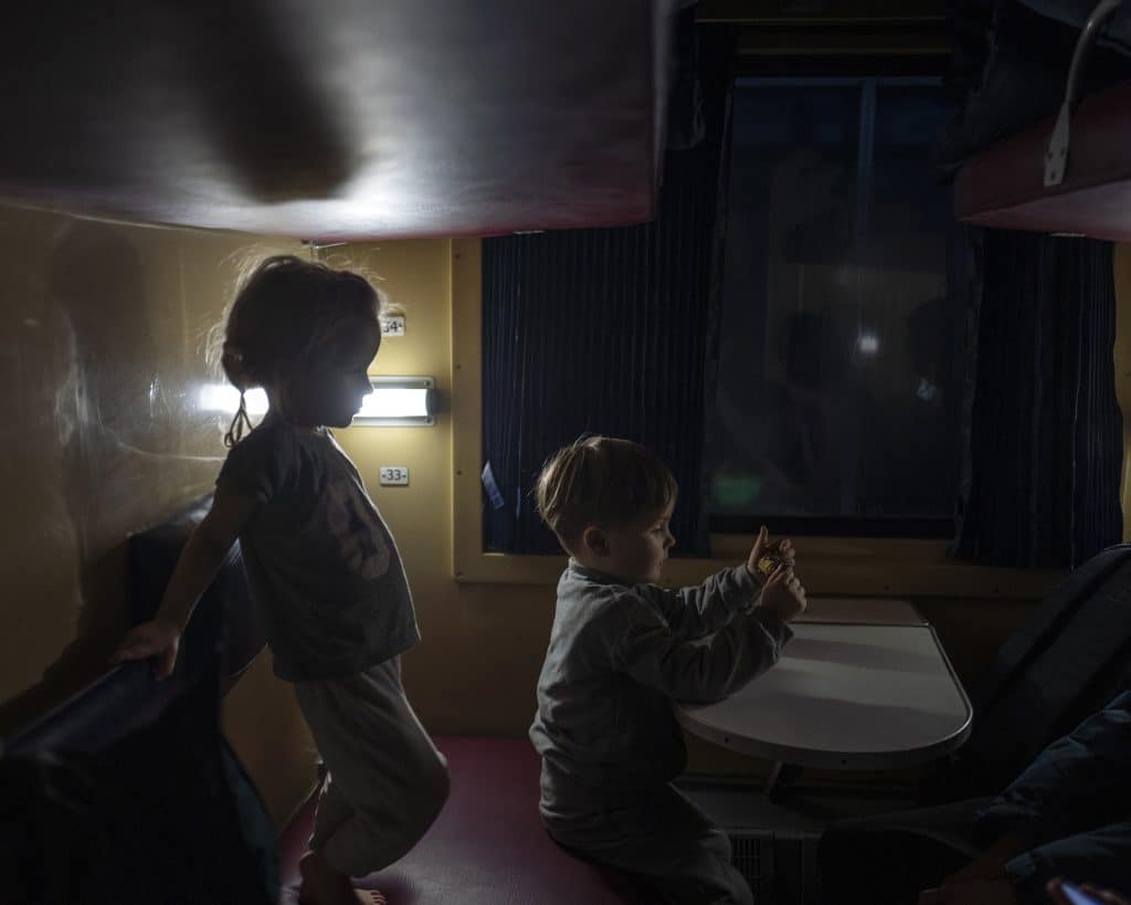 Ukrainian children on a train departing for western Ukraine from Kyiv Central Station, February 26, 2022. © Rafael Yaghobzadeh