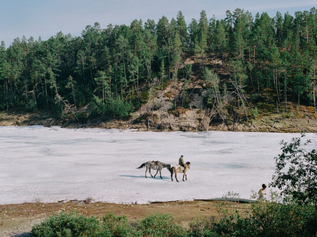 People walk along the Buluus glacier, which lies in a deep valley some 100 km from Yakutsk, and is a popular retreat in summer months when temperatures in the capital reach the high 30s Celsius, in Sakha, Siberia, Russia, on 16 June 2021. Permafrost beneath the glacier keeps at least part of it frozen through the summer months, but The Siberian Times reported local scientists as saying that glacial melt in the region has sped up in the past ten years. © Nanna Heitmann / Magnum Photos