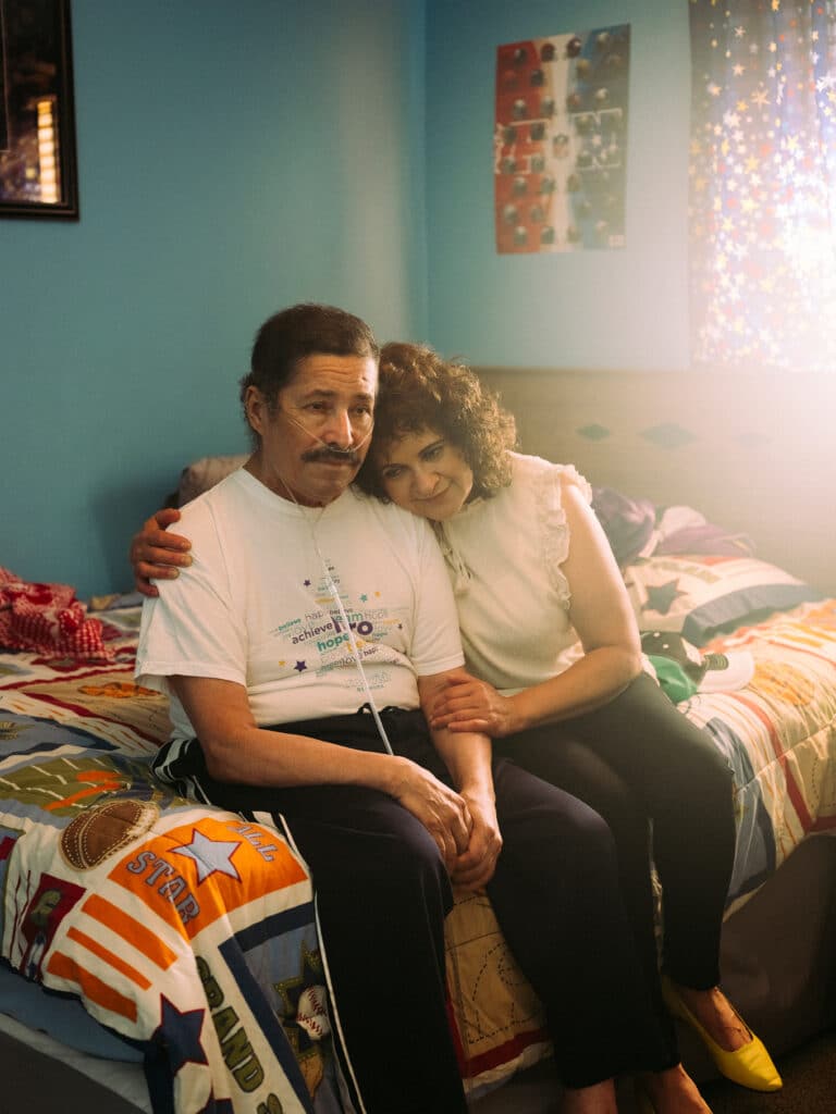 José sits in his room with his sister Sara, in Sioux Falls, South Dakota, USA, on 6 September 2020. Jose worked in a meatpacking plant until contracting COVID-19 in April 2020. He was in the hospital on a ventilator for five months, and still uses an oxygen cylinder. Sara also worked at the factory, but left to become a house cleaner. She took care of her brother during his illness. © Ismail Ferdous / Agence VU'