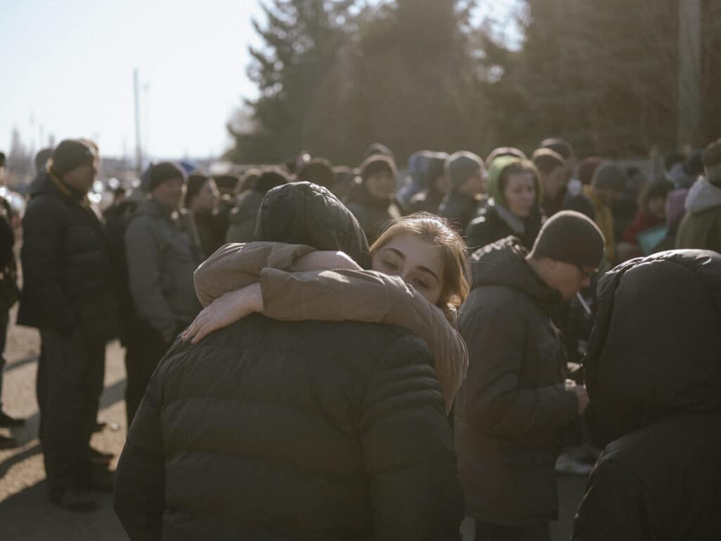 A young couple could not stop hugging - the man received a summon and reported to the military enlistment office for further instructions. © Ismail Ferdous / VU' for Blind