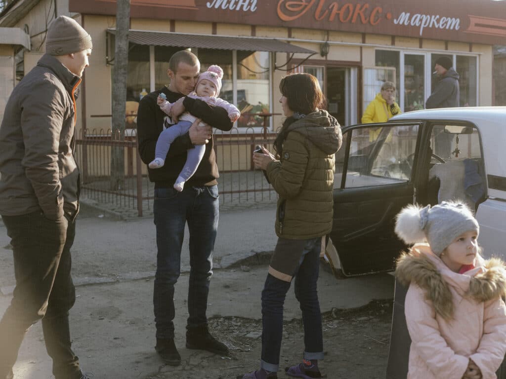 Ira, her mother Ruslana, her husband Yura, her kids Viktoriia, Yevheniia, Valeriia, and her father Yura. This young mother with three little children, said goodbye to her husband and parents near the Uzhhorod bus station. She and her children and a neighbour went to Slovakia without understanding where they were going after they decided to take their children to a safe place. © Ismail Ferdous / VU' for Blind