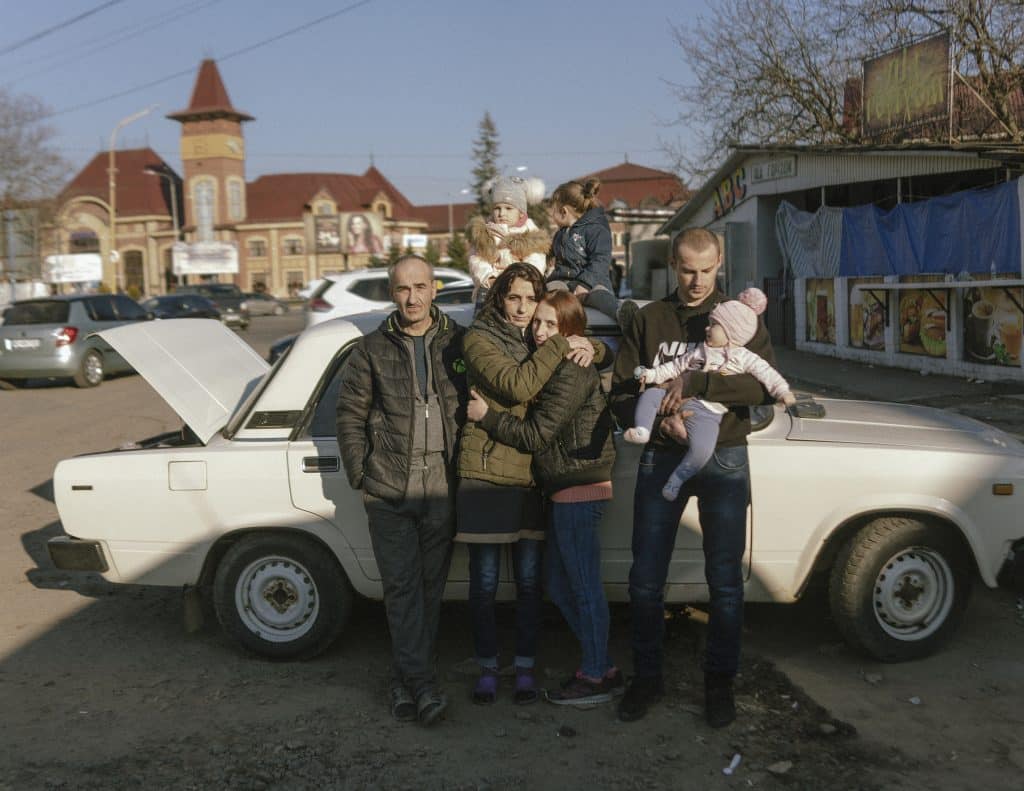 Ira, her mother Ruslana, her husband Yura, her kids Viktoriia, Yevheniia, Valeriia, and her father Yura. This young mother with three little children, said goodbye to her husband and parents near the Uzhhorod bus station. She and her children and a neighbour went to Slovakia without understanding where they were going after they decided to take their children to a safe place. © Ismail Ferdous / VU' for Blind