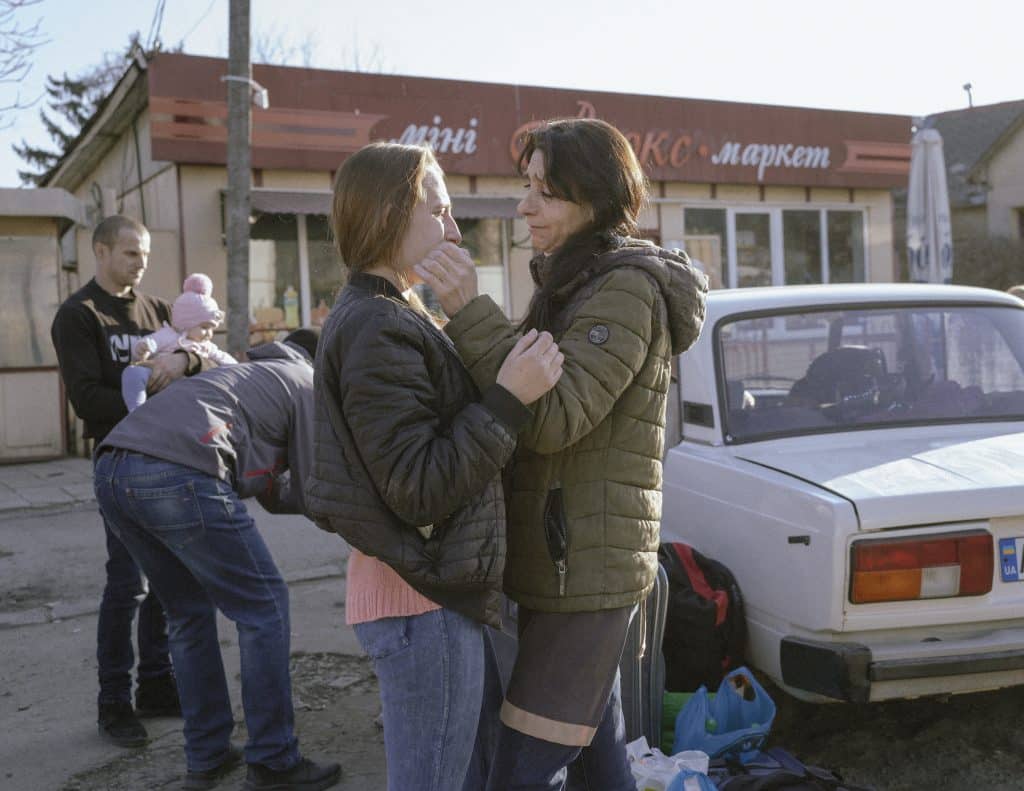 Ira, her mother Ruslana, her husband Yura, her kids Viktoriia, Yevheniia, Valeriia, and her father Yura. This young mother with three little children, said goodbye to her husband and parents near the Uzhhorod bus station. She and her children and a neighbour went to Slovakia without understanding where they were going after they decided to take their children to a safe place. © Ismail Ferdous / VU' for Blind