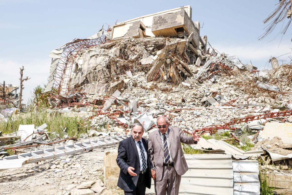 Administrators survey the ruins of Mosul University in East Mosul as the battle continues to rage on the west side of the Tigris River. They grudgingly evacuated out of range as a mortar barrage crept closer. Despite the nearby danger, hundreds of student and faculty volunteers rallied to clean and restore the damaged buildings. Before ISIS occupied Mosul, the university was one of the largest and most important educational and research institutions in the Middle East. During ISIS’s reign, it is estimated that 8,000 books and over 100,000 manuscripts in the library were destroyed. Mosul. Iraq. 2017. © Peter van Agtmael / Magnum Photos