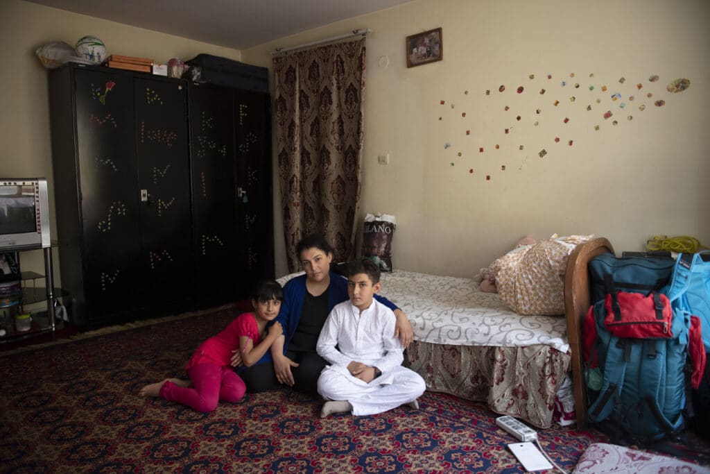 Wida Saghary, 32, and her two children live in hiding in a women’s shelter after she was threatened by a Mullah she criticized publicly, Kabul, Afghanistan, July 20, 2020 © Farzana Wahidy