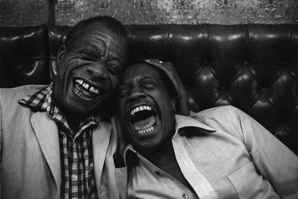 James Baldwin (L) and his brother David, dine in a Paris restaurant. St. Germain des Près, Paris, France. 1981 © Jane Evelyn Atwood