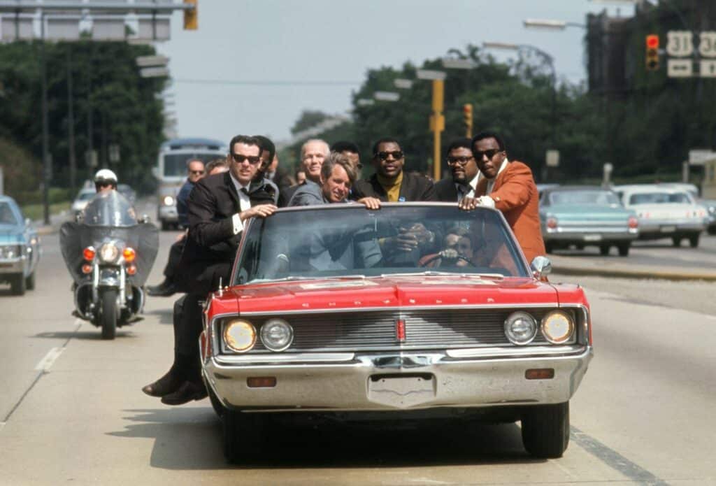 Bobby Kennedy fait campagne dans l'Indiana en mai 1968, avec divers assistants et amis : l'ancien boxeur Tony Zale et (à droite de Kennedy) les stars de la N.F.L. Lamar Lundy, Rosey Grier et Deacon Jones. ©Bill Eppridge Courtesy of Monroe Gallery of Photography