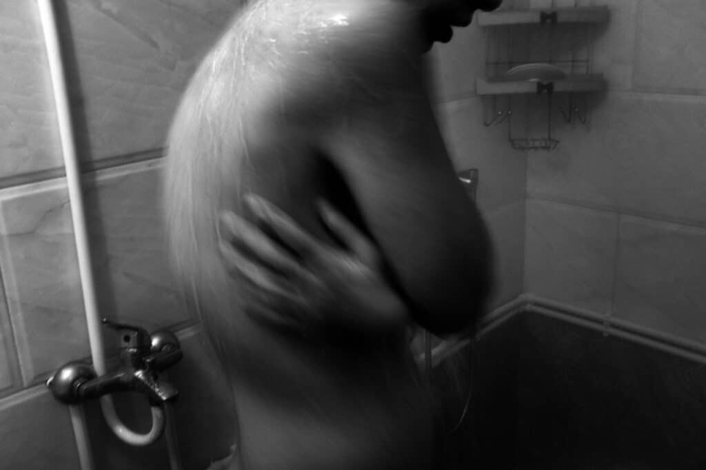 Sima takes a shower after every outing due to the horror of the COVID-19 virus, in Gilan province, Iran, November 12, 2020. © Farshid Tighehsaz