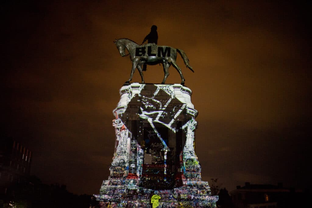 The Robert E. Lee statue on Monument Avenue has been repurposed by activists to become a gathering space hosting not only protests but also musical performances, teach-ins, families playing touch football, and other events. They have also rechristened the site “Marcus-David Peters Circle” — memorializing a 24-year old Black Richmond man shot and killed by police while experiencing a mental health crisis. Richmond, Virginia, July 10, 2020. © Alan Chin