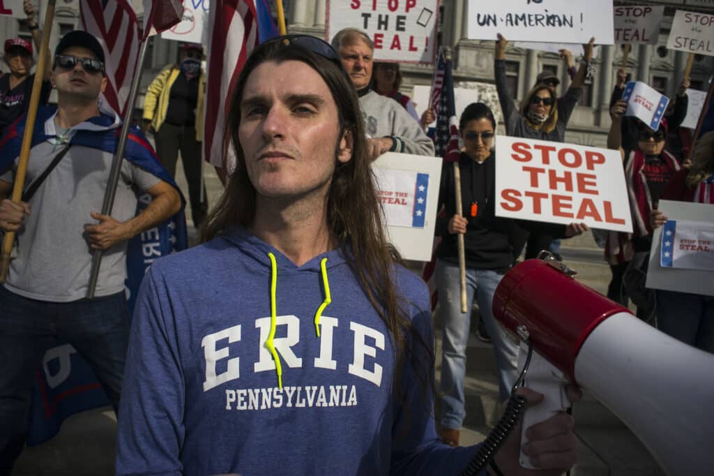 Conservative activist Scott Presler leads about a hundred pro-Trump demonstrators gathered on the steps of the Pennsylvania State Capitol building, protesting what they saw as fraud and wrongful procedures impacting the ongoing count of Pennsylvania's mailed-in ballots for the presidential election. Harrisburg, Pennsylvania, November 5, 2020 . © Alan Chin