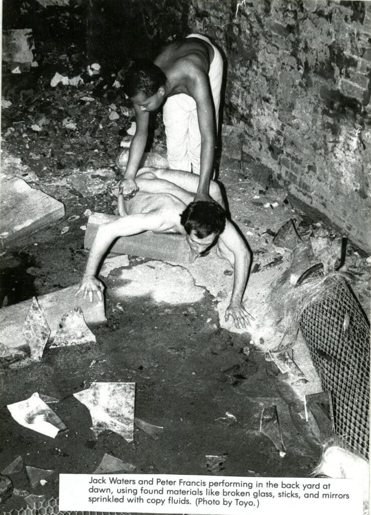 Jack Waters and Peter Francis performing in the backyard of ABC No Rio, 1983. Photo by Toyo