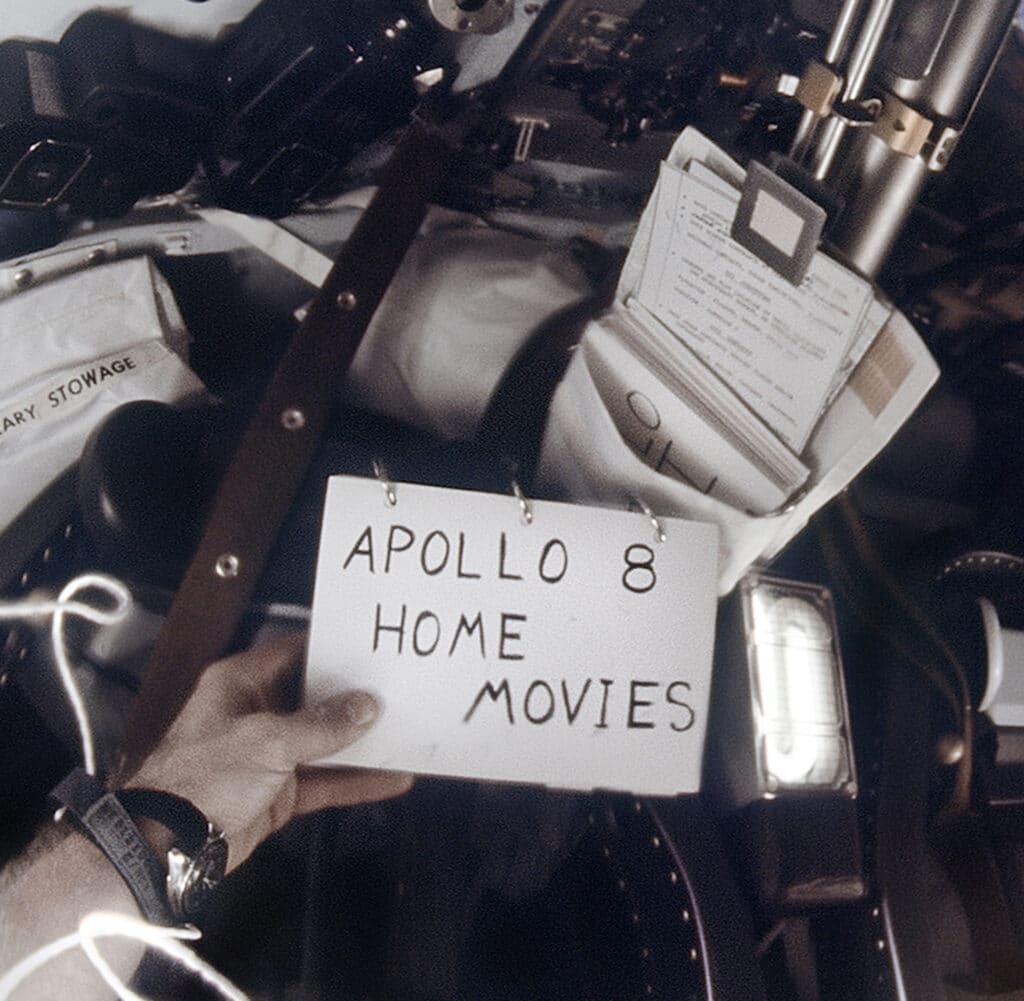 December 21-27, 1968, 80 frames of 16mm film, stacked and reprocessed ref NASA: Apollo 8 Mag 1013-R. Bill Anders films his prewritten tracking sheets to help document the mission that is about to unfold. Frank Borman can be seen in the commander's left seat. The two Hasselblad cameras for the mission, with their 80mm lenses and magazines, are in their storage bins, top left © NASA, Andy Saunders - Digital source: S Slater