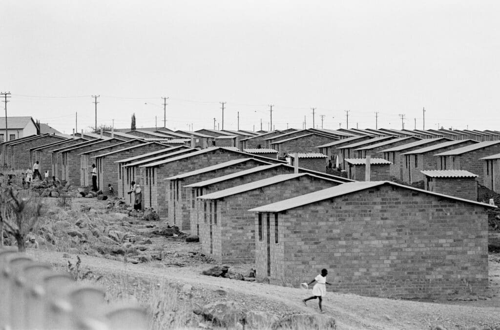 Mamelodi. Typical location has acres of identical four-room houses on nameless streets. Many are hours by train from city jobs. © Ernest Cole