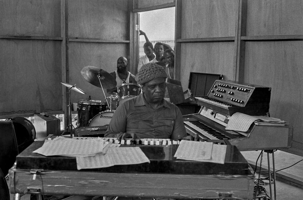 FESTAC Village: Sun Ra rehearsing on the keyboard, with Kamau Seitu (of the Wajumbe Cultural Ensemble) on tap drums, 1977 © Marilyn Nance / Artists Rights Society (ARS), New York