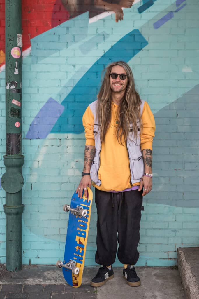 Portrait of skateboarder Yurii Korotun holding a skateboard with the Russian words "No War" color customized with the Ukrainian flag. Hanover, Germany. April 27th, 2022. © Thomas Girondel
