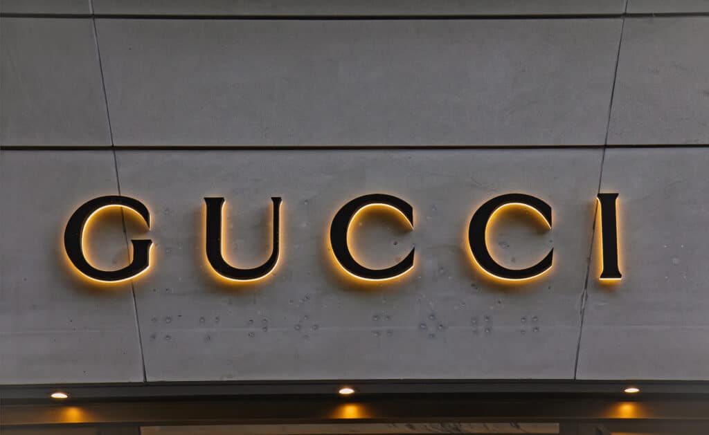 Zurich, Switzerland - August 3, 2022: Logotype logo sign of Gucci is an Italian luxury brand of fashion and leather goods, part of the Gucci Group, which is owned by the French holding company Kering.