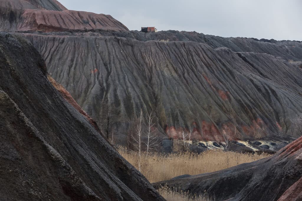 A view of the terricones, or slug mountains, that consist of solid waste remaining after coal mining in Toretsk, Donetsk region, Ukraine on March 30, 2021. The city of Toretsk is located in government-controlled territory, only a few kilometers away from the front line. It's been nearly seven years since the start of the war with Russian-backed militants, which has worsened the situation with uncontrollable mine flooding on the occupied territories of Donetsk and Luhansk regions. The floods could result in an environmental catastrophe in the Donbas region with around 39 mines in the non-government controlled territory being either in the process of flooding or already totally flooded due to war, a poor economy, and mismanagement. Scientists say that consequences could include the spontaneous release of gas, methane explosions in cellars, local earthquakes and, most dangerously, the contamination by toxic mine water of soil, lakes, rivers, and drinking water aquifers.