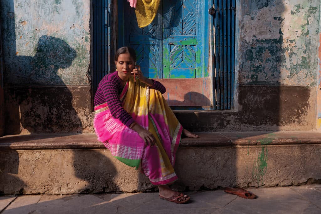 Shiuli, a 27-year-old sex worker, arranges to meet a client in the Kalighat red-light district of Kolkata, India. “A girl born to a poor family,” she said, “has to go through hell throughout her entire life.” Married at 13, Shiuli eventually left her abusive husband, taking their son with her, but her parents wouldn’t let her return home. She narrowly averted being trafficked. Unable to make enough as a maid, she became a sex worker. She has two other sons, fathered by clients. © Smita Sharma