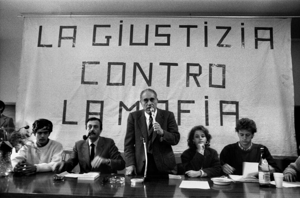 February 5, 1986. Galileo Galilei Science High School, conference Justice against the Mafia, member of the Superior Council of the Magistracy Alfredo Galasso on the left with a pipe. © Fabio Sgroi