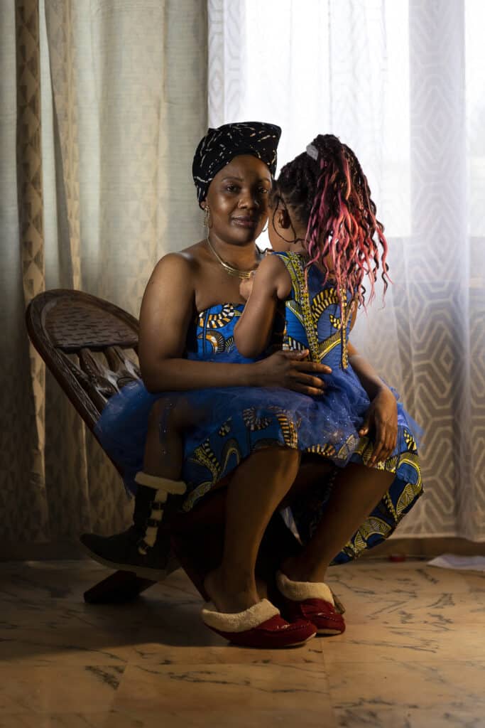 Corine Ekoto Saint-Jacques, 43 and her daughter Sara, 7, at home in the small village, Gay, in Champagne Ardennes region. Saint-Jacques family is the very first black family to instal themselves in the area. As Corinne says: " we make our best to avoid any misunderstood and we know we have to make more efoords for that in reason of being a black familly". Corine is a care giver professional, nurse attending at home she is dealing everyday with differnt people and questions about her double culture in France. © Carolina Arantes