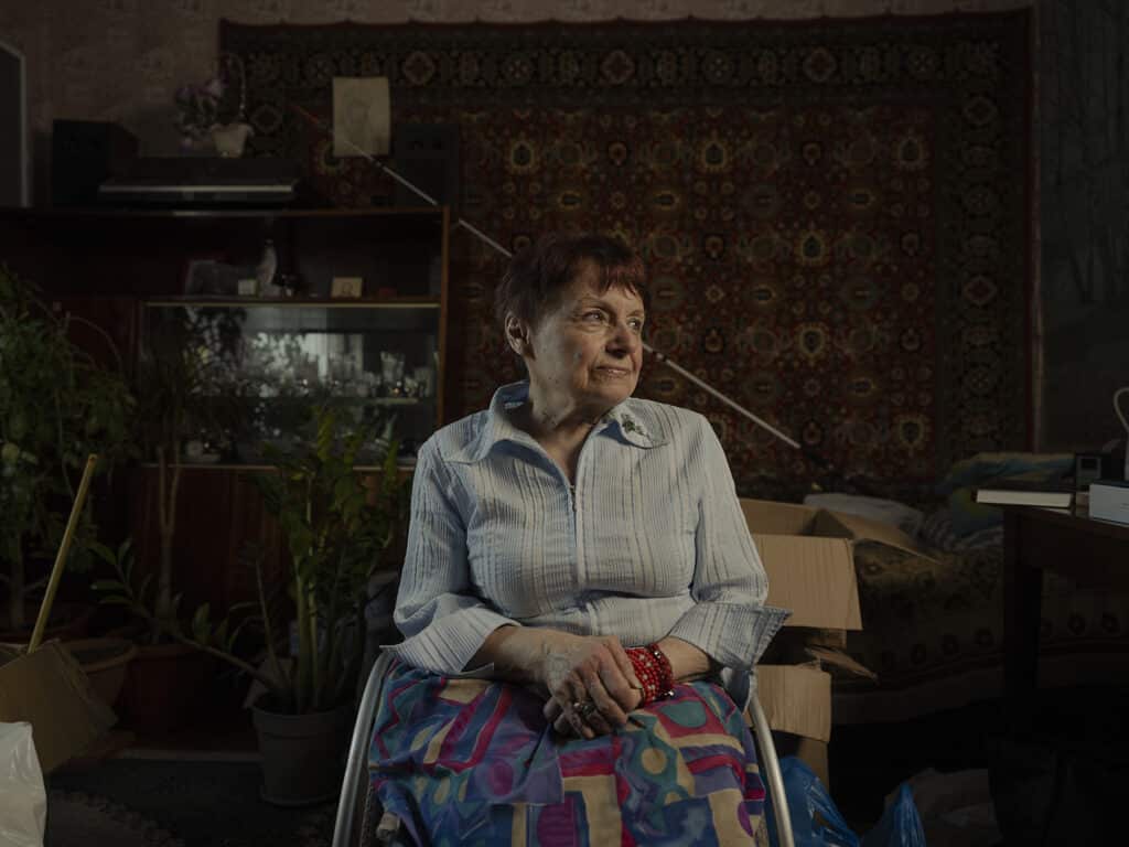 Olena Bondarenko in the bedroom where she stays after her apartment got damaged by shrapnel, Bakhmut, Ukraine on September 7, 2022 © Sasha Maslov I Institute