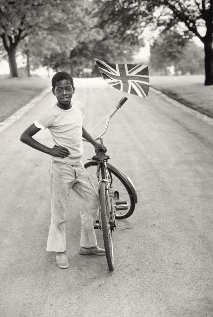 Boy with Flag, Winford in Handsworth Park, 1970, printed 2022. © Vanley Burke