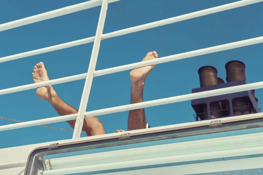 A passenger spends the long hours on deck on a ferry from Porto Torres in Sargaigne to Toulon.