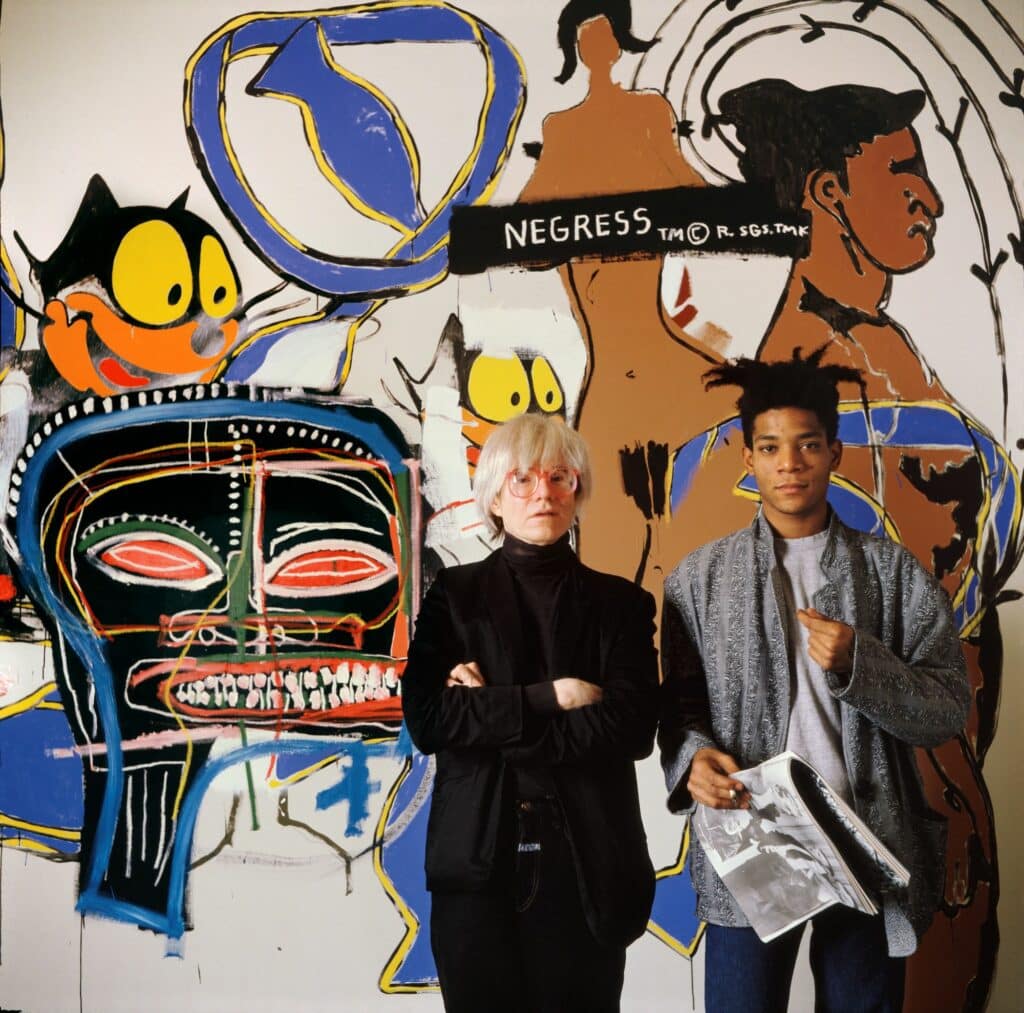 Sitting on box “Ahab,” Great Jones Street Studio, NYC, 1987. Tseng Kwong Chi © Muna Tseng Dance Projects Inc, Art: © Keith Haring Foundation, courtesy of Yancey Richardson Gallery