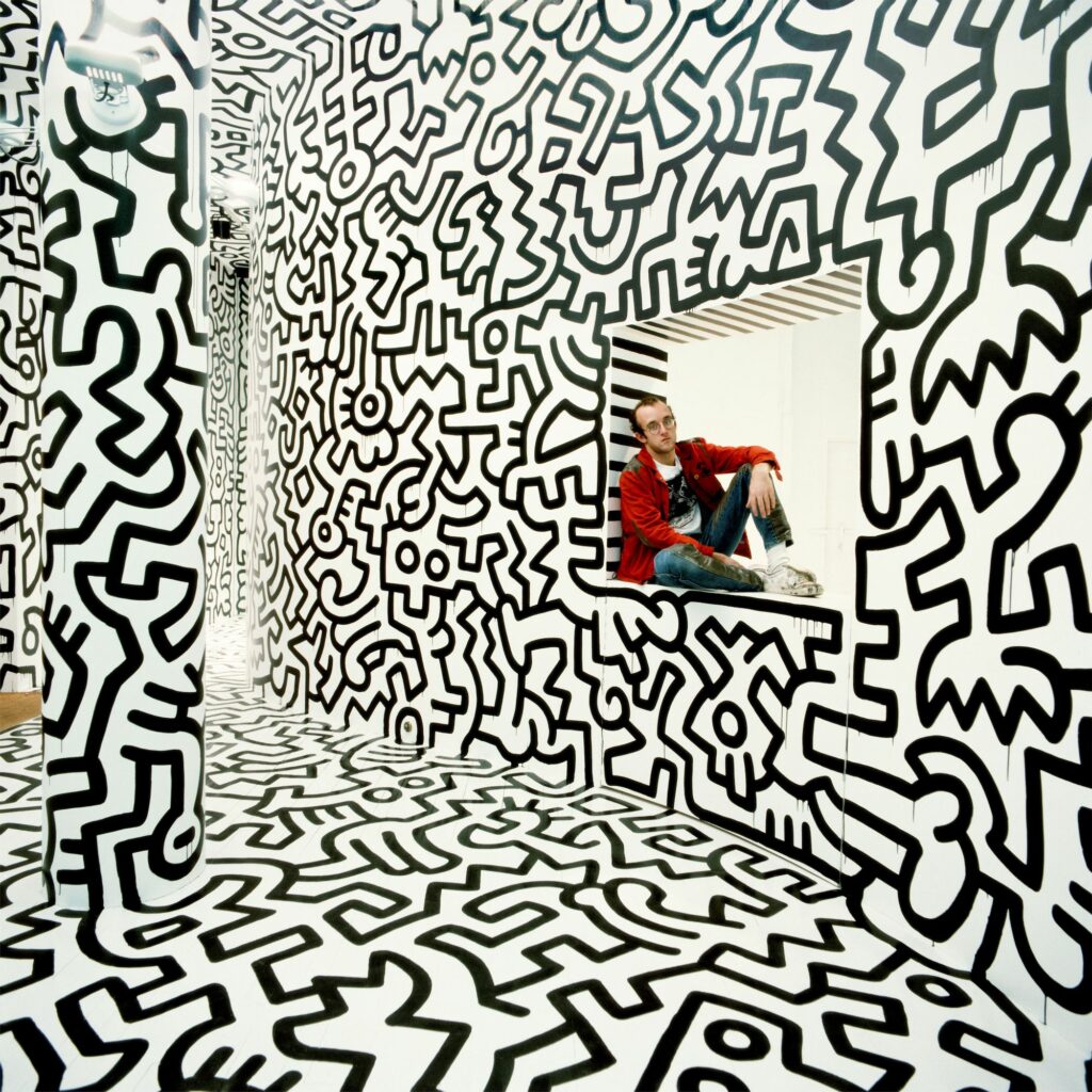 Keith Haring Pop Shop New York, 1986. Photo: Tseng Kwong Chi © Muna Tseng Dance Projects Inc, Art: © Keith Haring Foundation, courtesy of Yancey Richardson Gallery