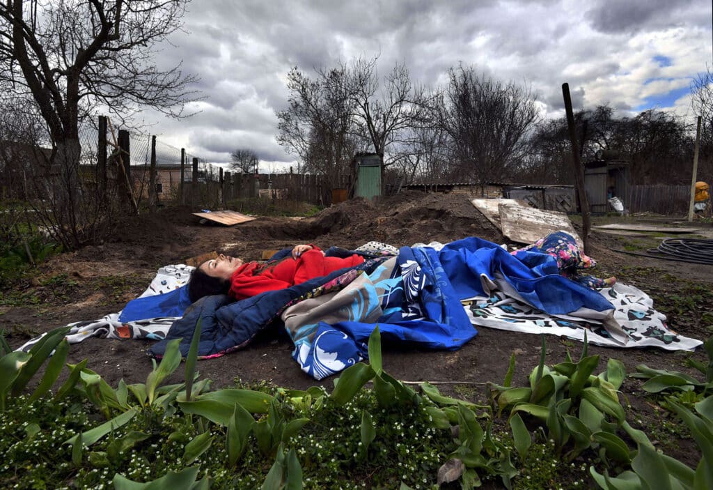 The body of Marina Naumec, 32 years old, was exhumed by her husband, friend Lesya and neighbors from a makeshift grave in the backyard of a home in Bucha, Ukraine on April 12, 2022. It is not known how she died, she did not wake up one day during the war and her friend Lesya begged for permission from the Russian troops to bury her. She left behind three children. There were three other people buried in this yard, all shot in the eye. Police and body collectors are now gathering bodies for proper burials and those that will be examined for war crimes evidence. Bucha was recently liberated from invading Russian troops in the suburbs of Kyiv where atrocities have been reported.