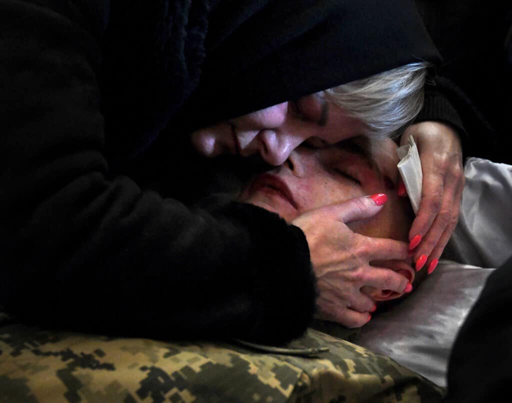 Ukraine mourds. Maria embraces the body of her son, Didykh Taras as a funeral is held for three Ukrainian soldiers killed in the Russian invasion at Church of the Most Holy Apostles Peter and Paul in Lviv, Ukraine on March 11, 2022. Many sorrowful funerals take place here for fallen troops and the wails of weeping loved ones echo on the walls.