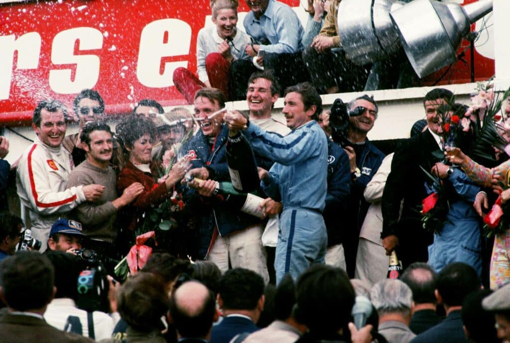 Crowds celebrate as Mexican driver Pedro Rodriguez and Belgium driver Lucien Bianchi are pushed through lines of people in their Ford GT40 car in Gulf Oil colors after claiming another victory for the manufacturer in 1968. The drivers led for 17 of the 24 hours.