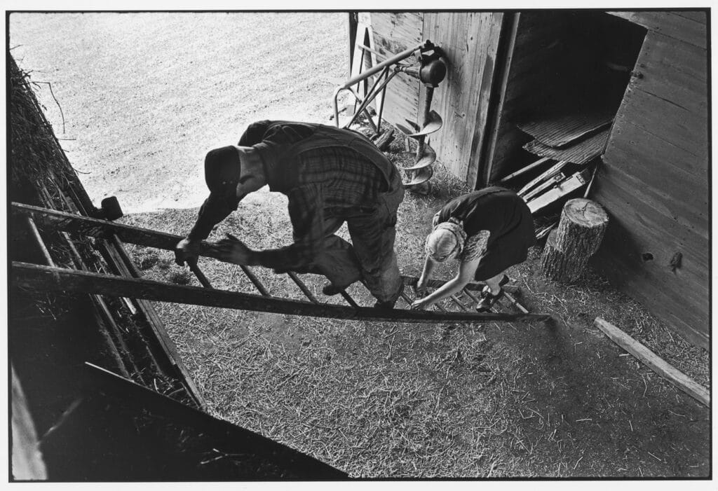 Anna and Flander Hamlin climb up to the hayloft in their barn. © David Turnley / Corbis / VCG via Getty