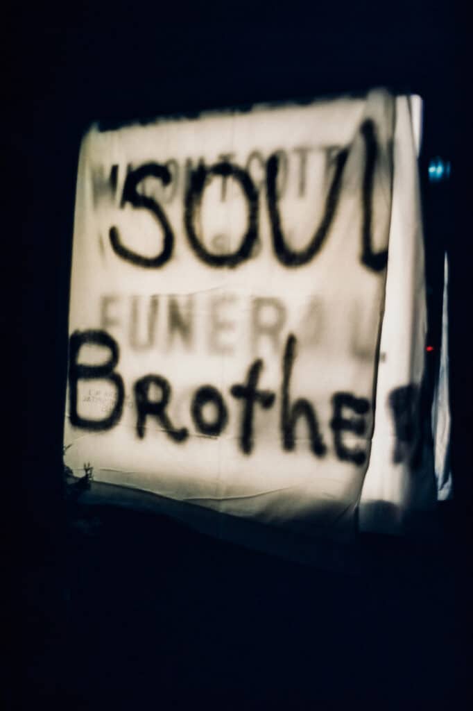 A Soul Brother notice hung over the sign of a black owned business in Newark © Bud Lee, Estate of Bud Lee
