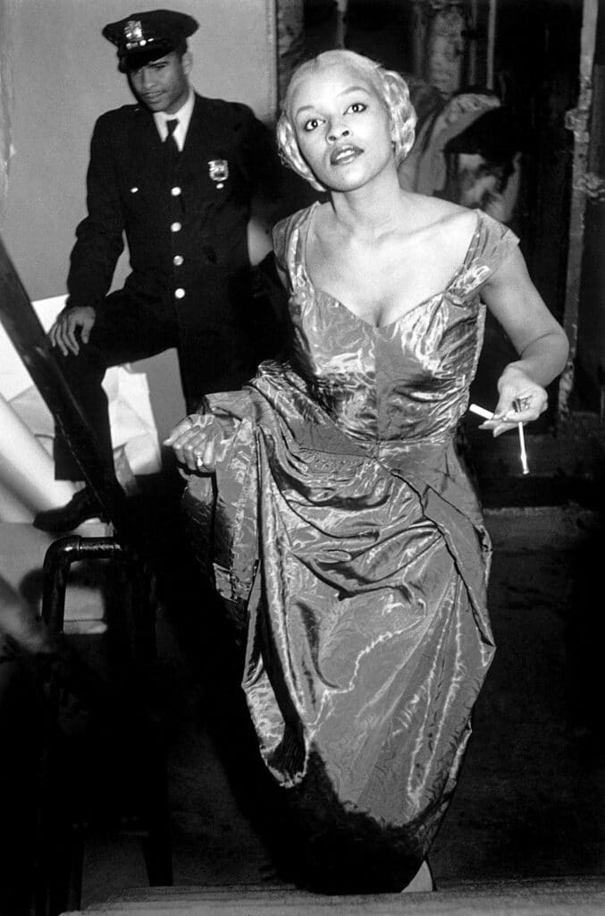 USA. New York City. Harlem. Model Charlotte Stribling aka 'Fabulous' waits backstage for the entrance cue to model clothes designed and made in the Harlem community. 1950.