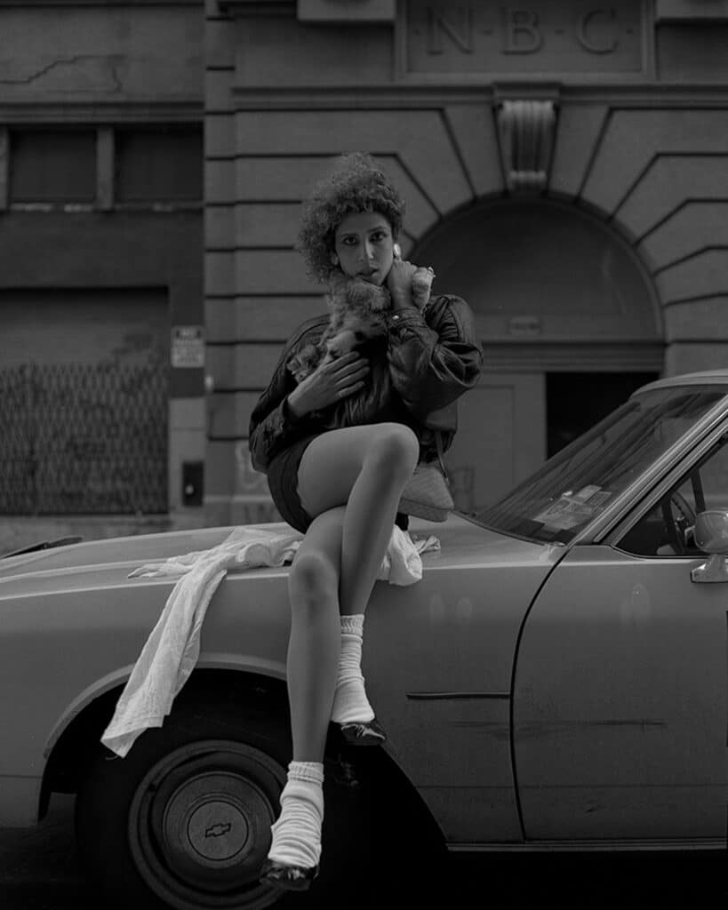 Everlyn sitting on the undercover car, 16th street, Meatpacking District, 1992 © Katsu Naito