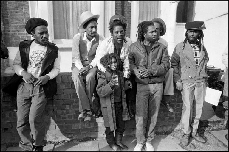 Dennis Brown (veste blanche) avec son fils Daniel Brown, Vivian Jones avec le chapeau blanc et Mike Brooks devant les Hive Recording Studios, à Stoke Newington, Londres, le 24 février 1985.