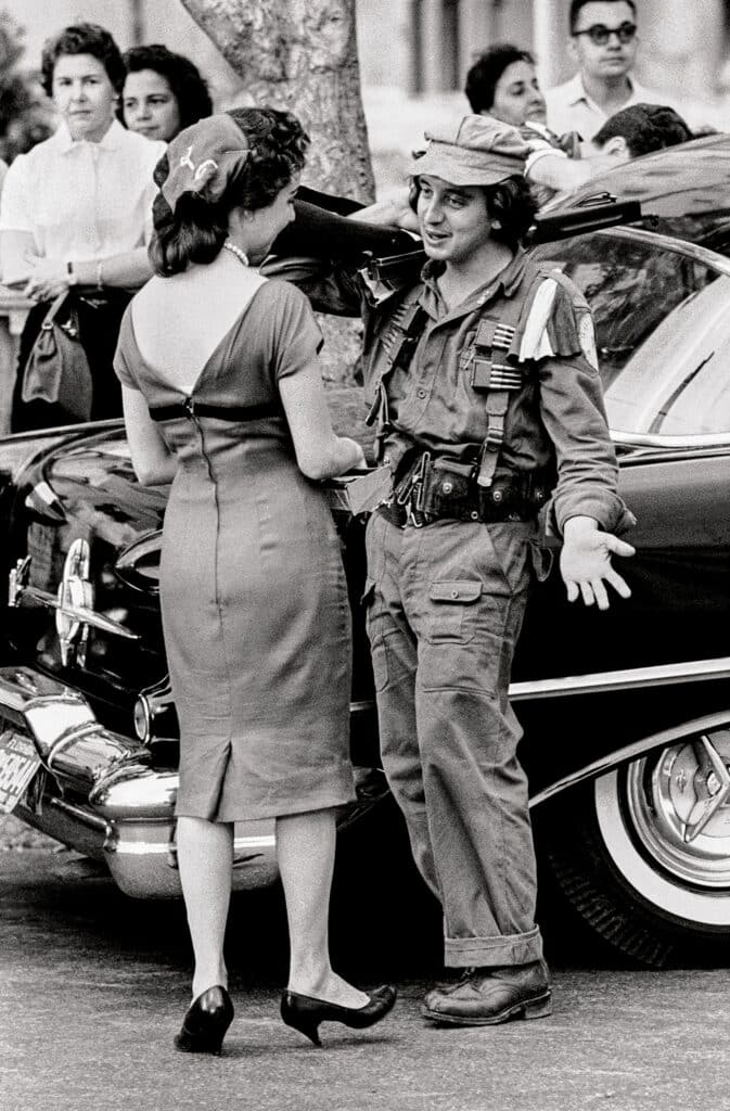 CUBA. La Havana. 1959. Young "guerillero" in from hiding speaks to his first civillian lady.