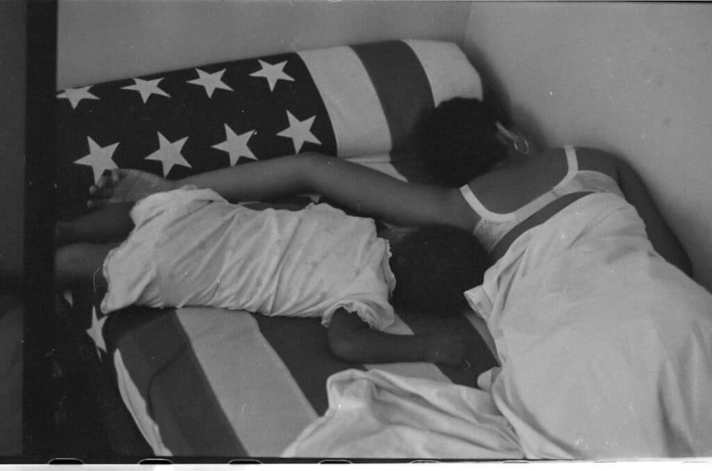 William Melvin Kelley 1937 - 2017 Gail and Jesi on Grandpa Will’s Flag, 4 Rue Regis, 1967 Stamped by Artist's Estate Selenium washed gelatin silver print from the original negative Gelatin silver print from the original negative 11 x 14 in. / Image 9 x 13 in. 28 x 35,5 cm / Image 22,8 x 33 cm